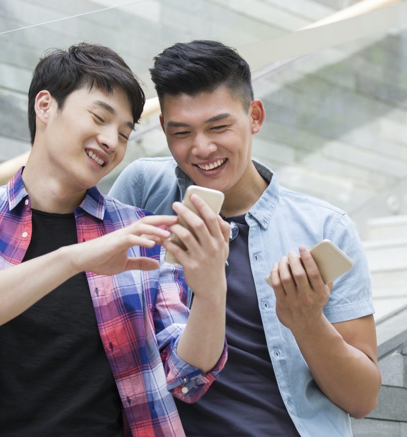 Young friends looking at a smart phone